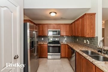 Charlotte house for rent - full kitchen with stainless steel appliances and granite counter tops and wood cabinets