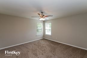 Charlotte house for rent - a bedroom with carpet and a ceiling fan