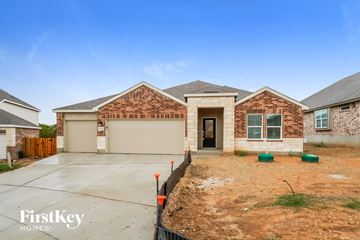 New Braunfels house for rent - a new brick house with a driveway and a garage door