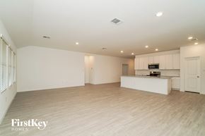 New Braunfels house for rent - an empty living room and kitchen with white cabinets