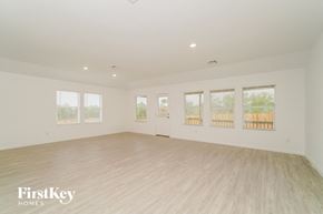 New Braunfels house for rent - a spacious living room with white walls and wood floors