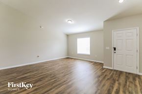 Palm Coast house for rent - A room with wooden floors and a white door.