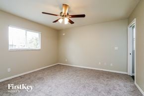 Cape Coral house for rent - a bedroom with a ceiling fan and a window