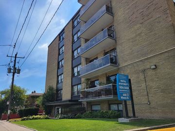 York apartment for rent - a brick apartment building with a street sign in front of it