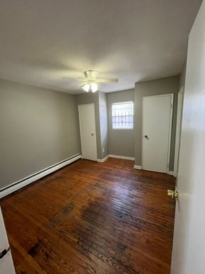 Louisville apartment for rent - A room with wooden floors and white walls.