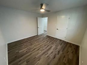 Sacramento apartment for rent - A room with wooden flooring and two white doors.