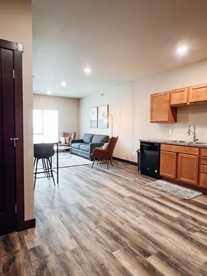 Watertown apartment for rent - A kitchen with wooden cabinets and a black dishwasher.