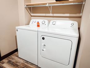 Watertown apartment for rent - Two white washing machines in a laundry room.