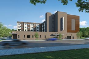 Watertown apartment for rent - A modern building with a cafe on the ground floor.