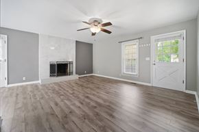 Jacksonville house for rent - A spacious living room with a fireplace and hardwood floors.