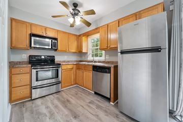 Jacksonville house for rent - A kitchen with wooden cabinets and stainless steel appliances.