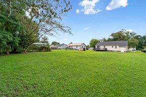 Jacksonville house for rent - A large grassy field with a few houses in the distance.