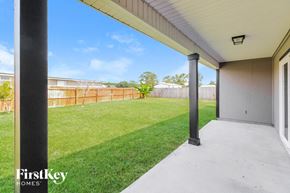 Green Cove Springs house for rent - A patio area with a view of a fence and trees.