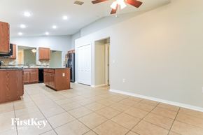 Palmetto house for rent - a kitchen and living room with tile flooring and a ceiling fan
