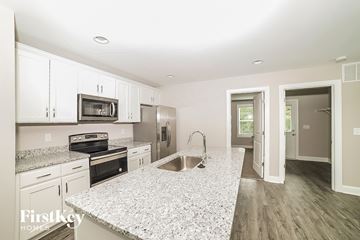 Winston Salem house for rent - A kitchen with granite countertops and stainless steel appliances.