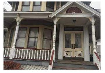 Peekskill apartment for rent - the front facade of a house with columns and a porch
