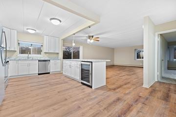 North Riverside apartment for rent - A kitchen with white cabinets and a wood floor.