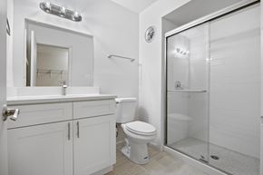 North Riverside apartment for rent - A white bathroom with a toilet, sink, and shower.