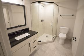 Rochester apartment for rent - A bathroom with a sink, toilet, and shower.