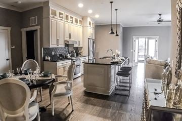 Rochester apartment for rent - A modern kitchen with a dining table set for four.