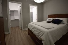 Rochester Hills apartment for rent - A bedroom with a bed, dresser, and closet.