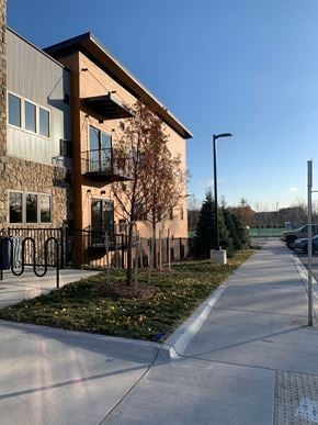 Rochester Hills apartment for rent - A modern building with a bicycle rack in front.
