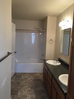Stanley apartment for rent - A bathroom with a sink, mirror, and shower.