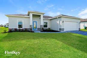 Cape Coral house for rent - a white house with a lawn in front of it