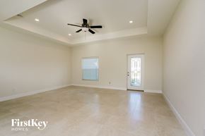 Cape Coral house for rent - an empty living room with a ceiling fan