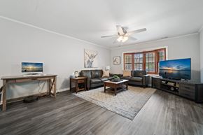 Jacksonville house for rent - A living room with a television, a couch, and a rug.