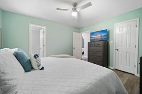 Jacksonville house for rent - A bedroom with a bed, dresser, and a ceiling fan.