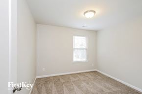 Winston Salem house for rent - a bedroom with white walls and carpet and a window