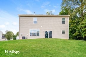 Winston Salem house for rent - the back of a house on a grassy hill