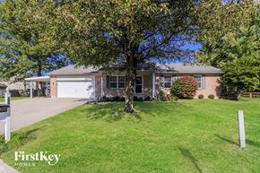 Maineville house for rent - A tree in front of a house with a sign that says FirstKey Homes.