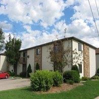 Neenah apartment for rent - an apartment building with a red car parked in front of it