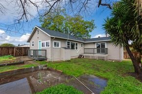 Lemon Grove house for rent - A house with a grey roof and a small pond in front.