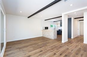 San Diego house for rent - a living room with a kitchen and a wooden floor