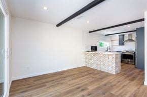 San Diego house for rent - a living room with a kitchen and a wooden floor