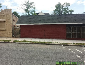 Newark apartment for rent - a red garage with a black roof next to a street