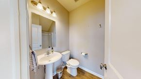 Crown Point house for rent - A white sink and toilet in a small bathroom.