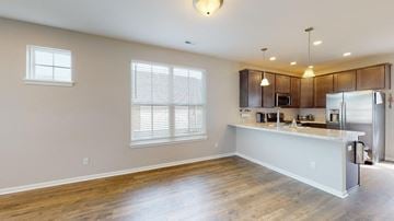Crown Point house for rent - A kitchen with wooden floors and a white countertop.