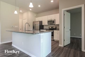 Port Charlotte house for rent - a kitchen with an island and a stainless steel refrigerator