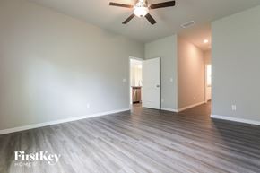 Port Charlotte house for rent - a living room with hardwood floors and a ceiling fan