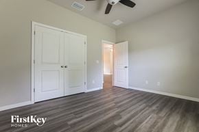 Port Charlotte house for rent - a bedroom with two closets and a ceiling fan