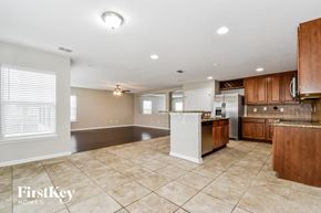 Jacksonville house for rent - a kitchen with brown cabinets and a white counter top