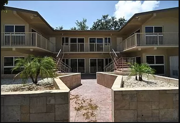 North Miami apartment for rent - an apartment building with palm trees in front of it