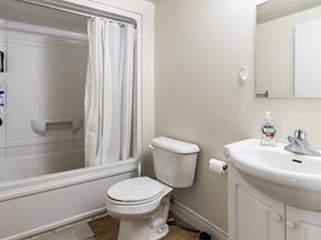 Waterloo apartment for rent - A white toilet sits next to a white sink in a bathroom.