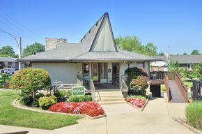 Louisville apartment for rent - A small building with a green sign that says "Office" in front of it.