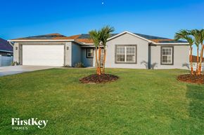 Cape Coral house for rent - A house with a grey roof and a white garage door is shown.