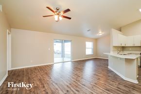 Cape Coral house for rent - A spacious room with a ceiling fan and wooden flooring.